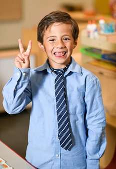 Child smiling after graduating from Yuma Pre-School