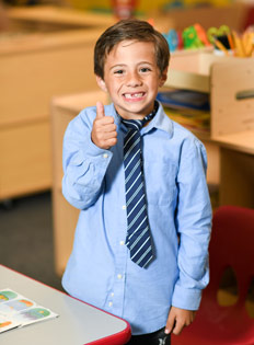 Child smiling after graduating from Yuma Pre-School